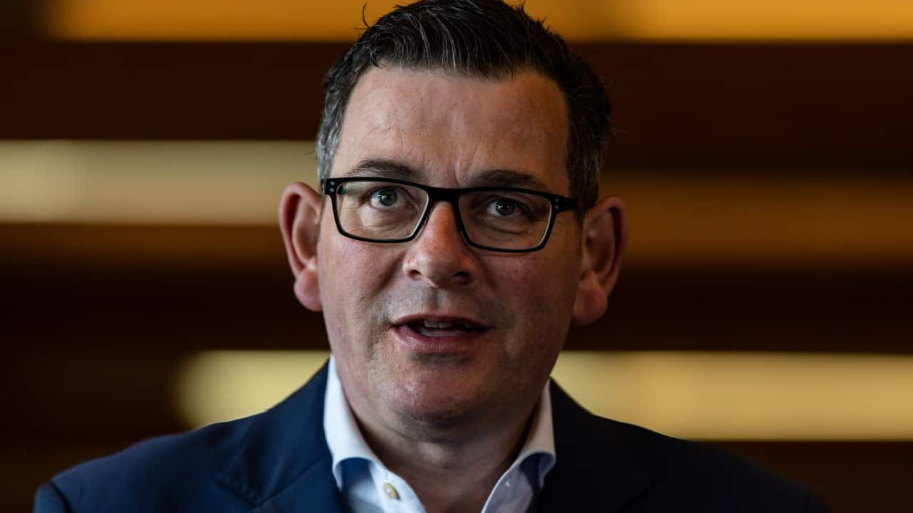 A man wearing a suit and glasses