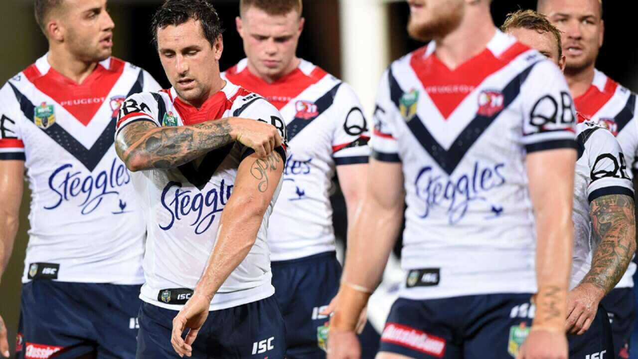 Roosters players are dejected following a Titans try