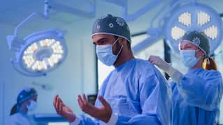 Close-up of surgeon preparing for operation.