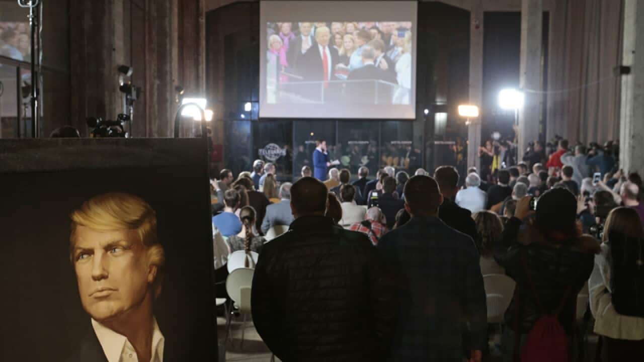 People watch the US presidential inauguration ceremony in Moscow