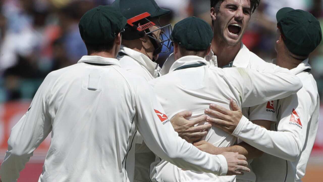 Australia's Pat Cummins with teammates celebrates