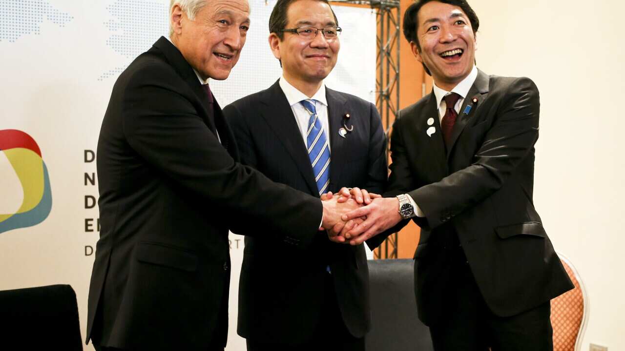 Chile's Foreign Affairs Minister Heraldo Munoz, left, shakes hands with Japan's State Minister Tako Ochi, center, and Toshinao Nakagawa, right, Parliamentary Deputy Minister of Economy, Trade and Industry