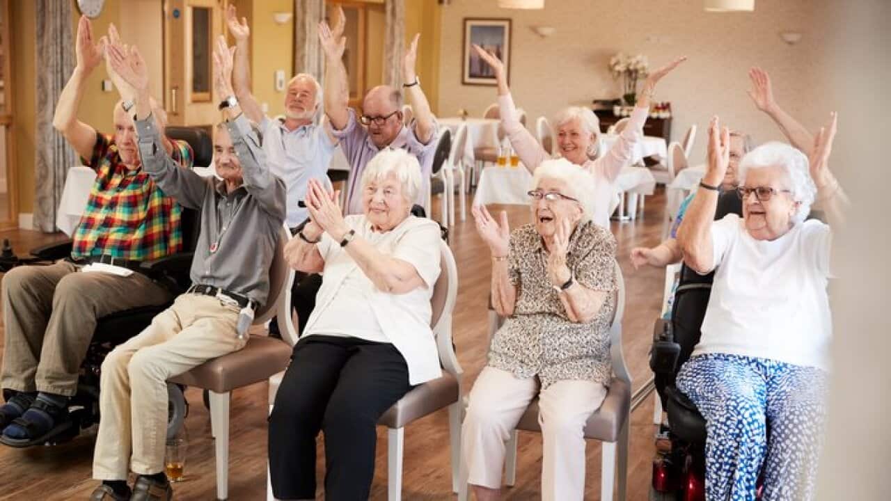 Group Of Seniors Enjoying Fitness Class In Retirement Home