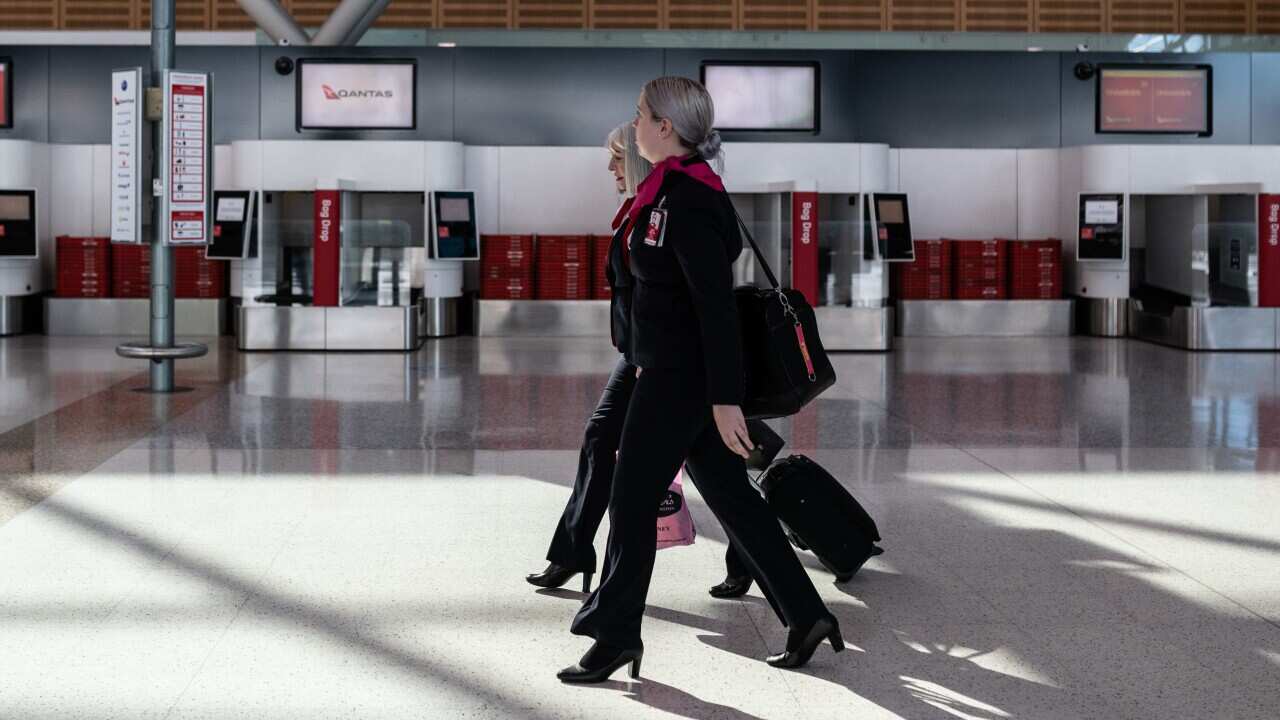Aircrew walking through the Qantas Terminal at Sydney Airport, Friday, 19 June, 2020.