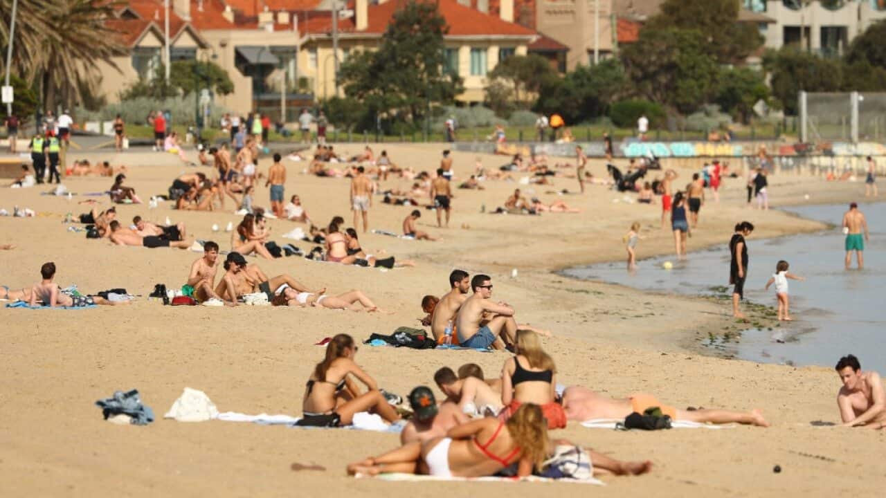People are seen at St Kilda Beach on March 27
