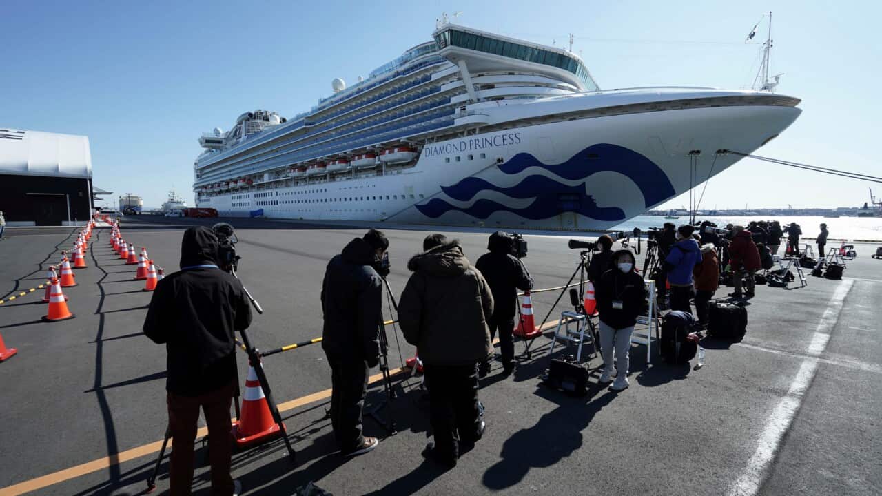 TV crews film the cruise ship Diamond Princess as it sits in quarantine in Yokohama
