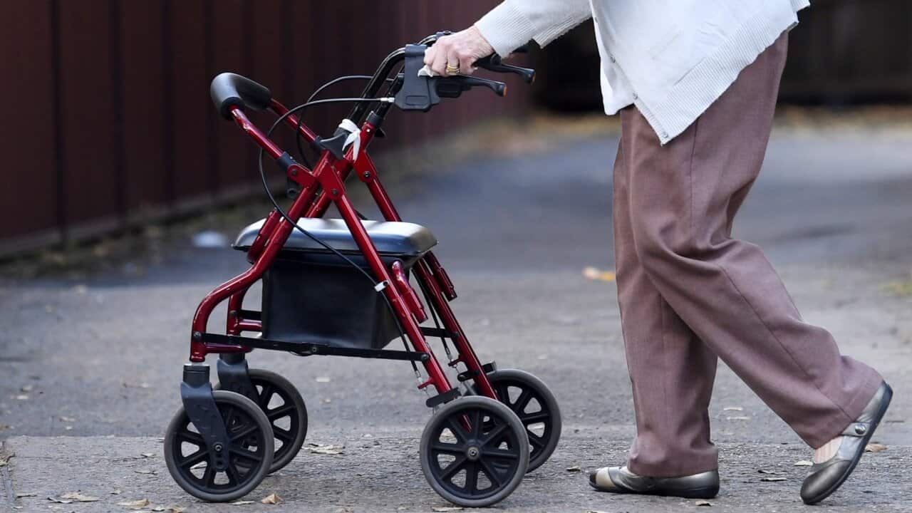 An elderly woman uses a mobility walker in Sydney on Sunday, April 30, 2017. (AAP Image/Paul Miller) NO ARCHIVING