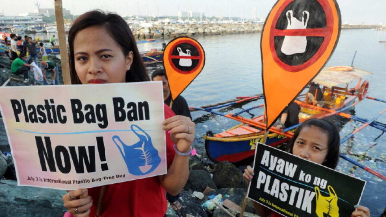 Environmental activists and volunteers hold placards calling for a ban of the use of plastic bags in Manila (JAY DIRECTO/AFP/Getty Images)