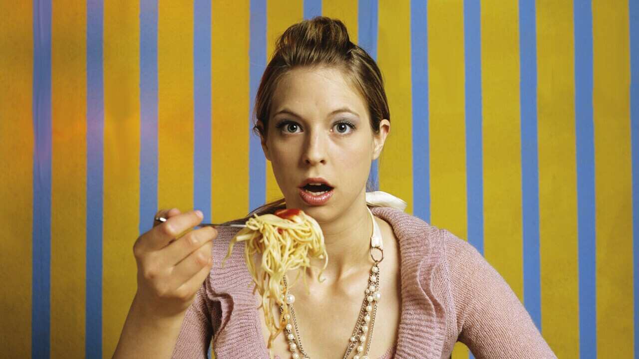 Woman eating spaghetti
