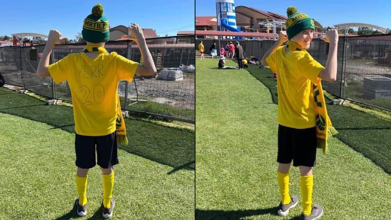 A young boy wearing a homemade Sam Kerr costume.