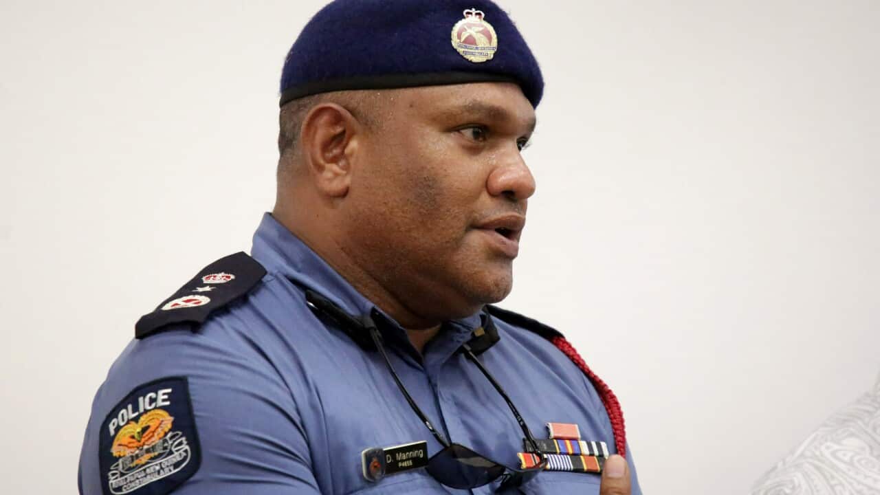 A man wearing a police uniform speaks.