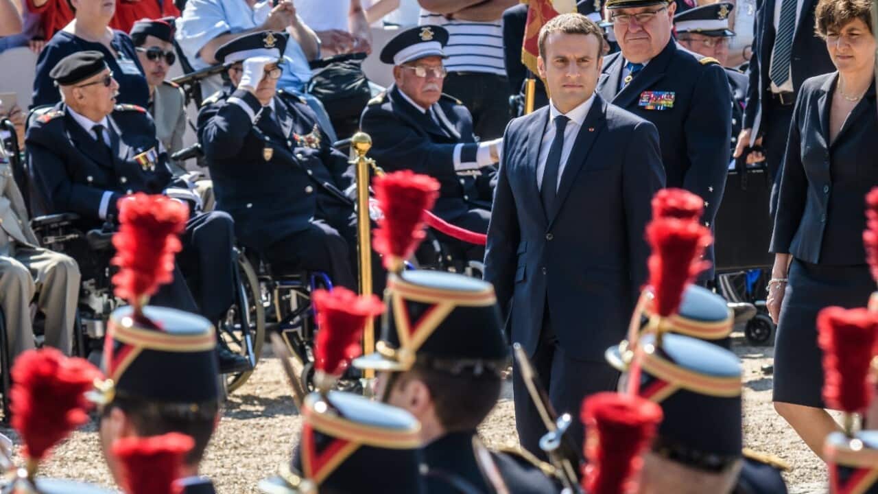 French President Emmanuel Macron (R) attends at a ceremony to mark the 77th anniversary of General Charles de Gaulle's appeal of 18 June 1940, 