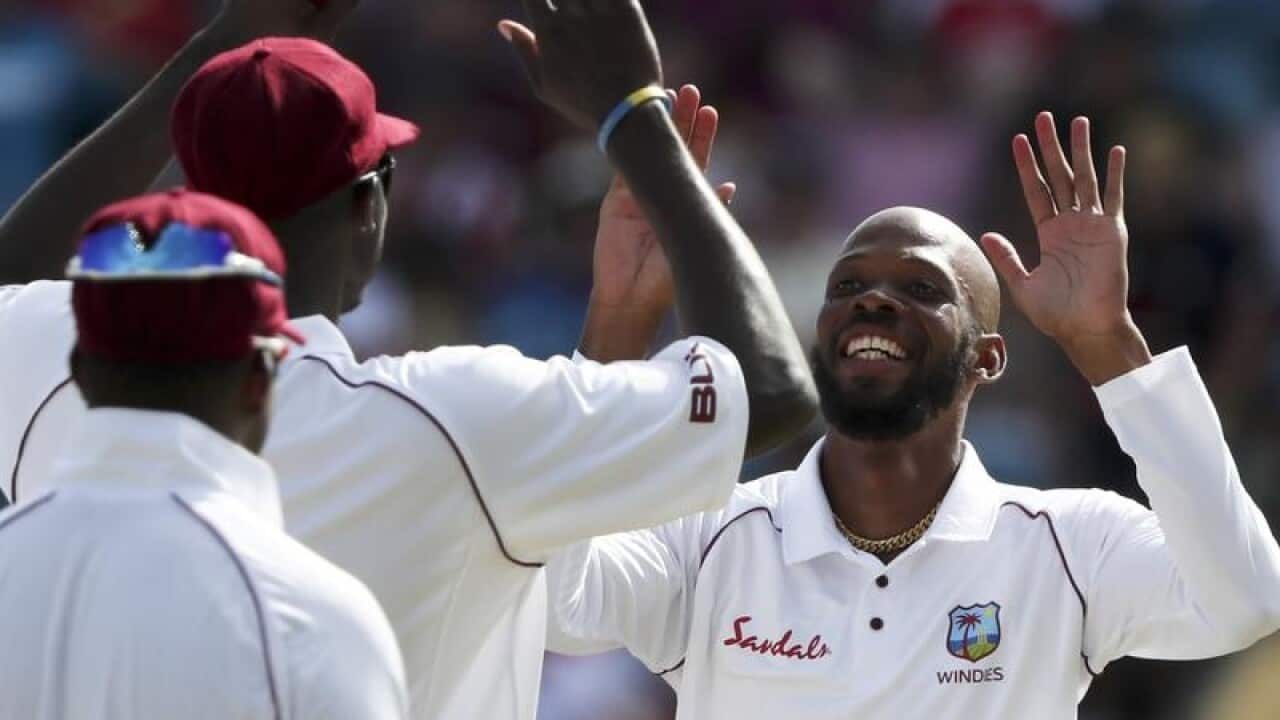 West Indies bowler Roston Chase (R)