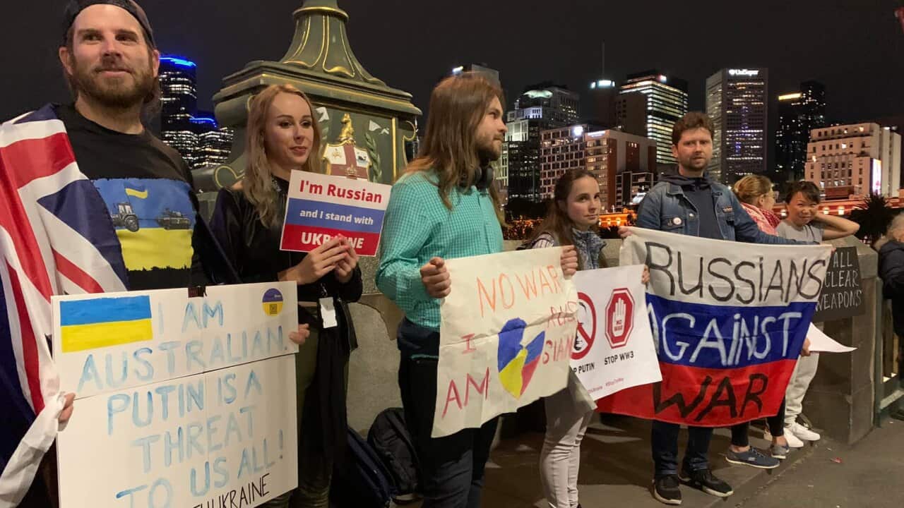 Daniel Mitchell (L) stands with Russians against the war in Ukraine.