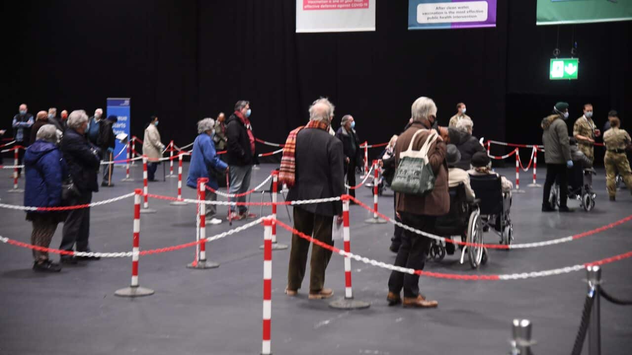 Londoners queue up a mass vaccination centre.
