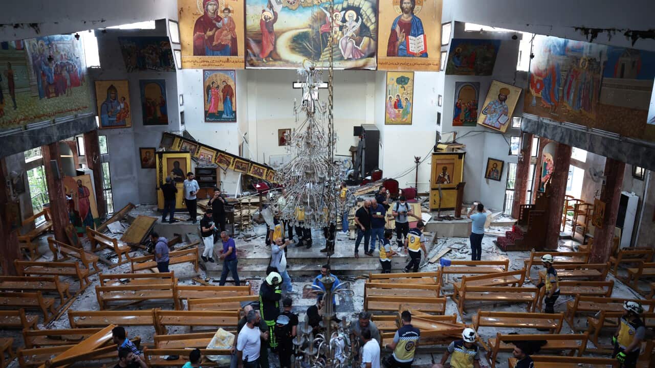 The scene inside the church following the attack shows major damage inside, with pews scattered and general destruction.