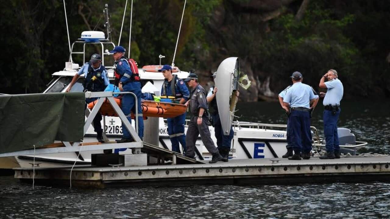 Body of a passenger aboard a seaplane that crashed is brought ashore.