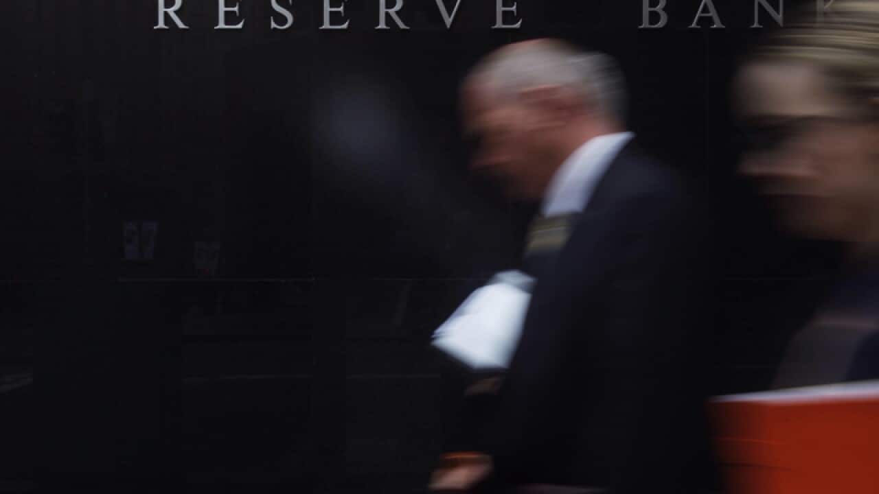 Pedestrians walk past the Reserve Bank of Australia in Sydney
