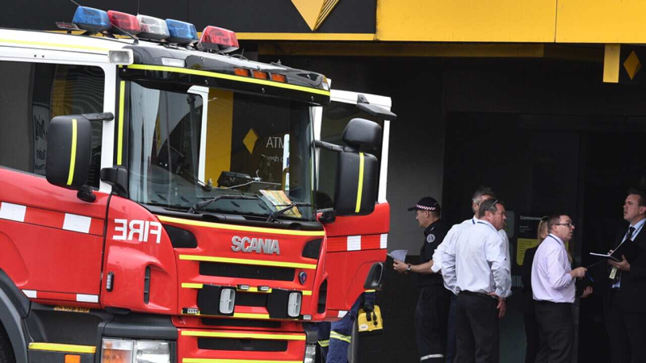 Emergency service workers are seen at the bank in Melbourne