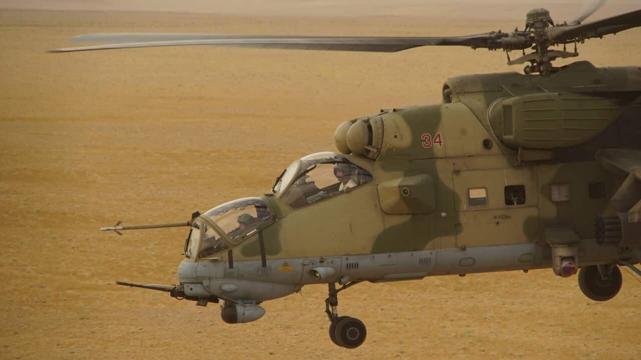 A Russian military helicopter flies over the desert in Deir es-Zor province in September 2017.