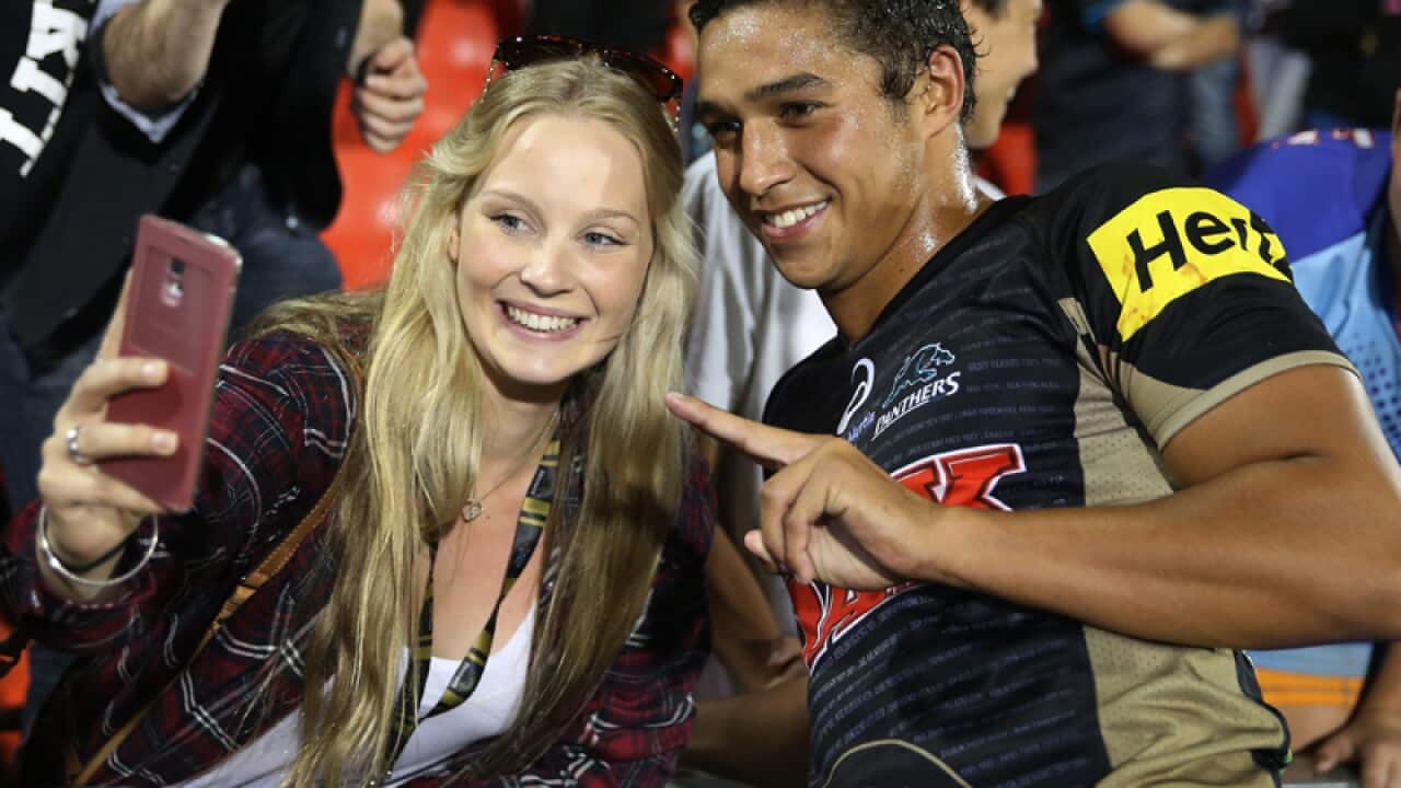 Te Maire Martin of the Panthers takes selfies with fans