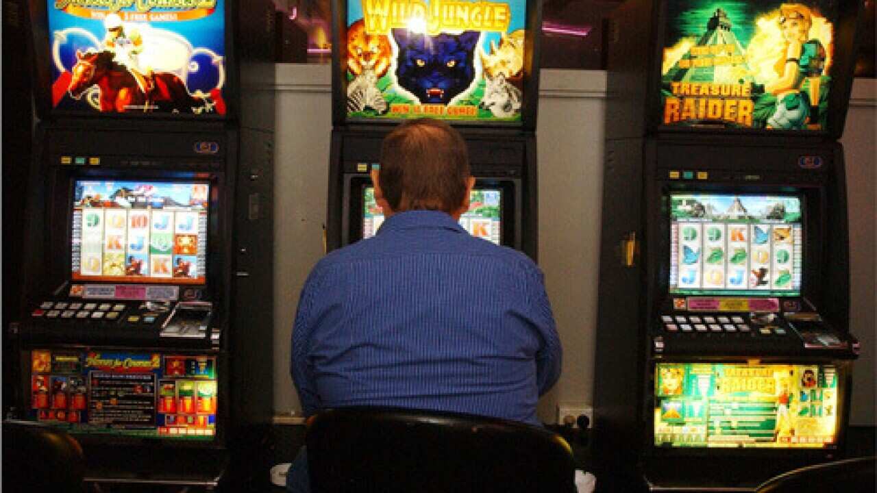 Sydney, May 3, 2004. A punter playing the poker machines in a Sydney club today.