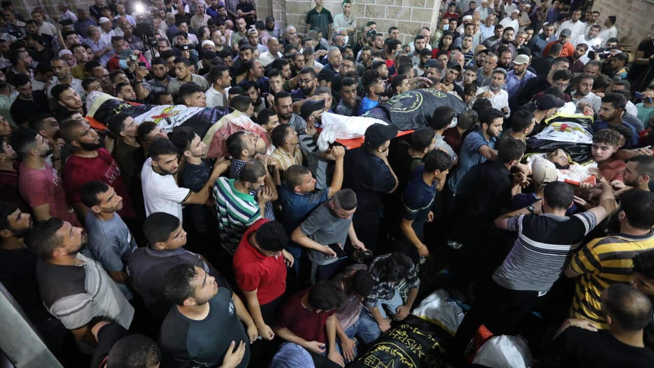 Palestinian mourners carry the bodies of the victims killed earlier in an Israeli air strike, during their funeral in Gaza City, on 5 August, 2022.