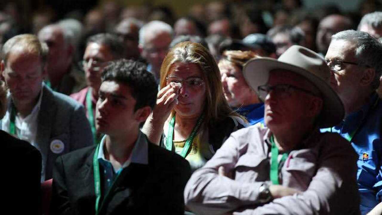 A woman reacts as she watches Prime Minister Scott Morrison deliver the National Apology to victims and survivors of Institutional Child Sexual Abuse.