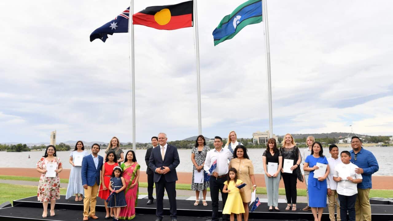 Prime Minister Scott Morrison poses for a photo with new citizens during an Australia Day Citizenship Ceremony and Flag Raising event in Canberra.