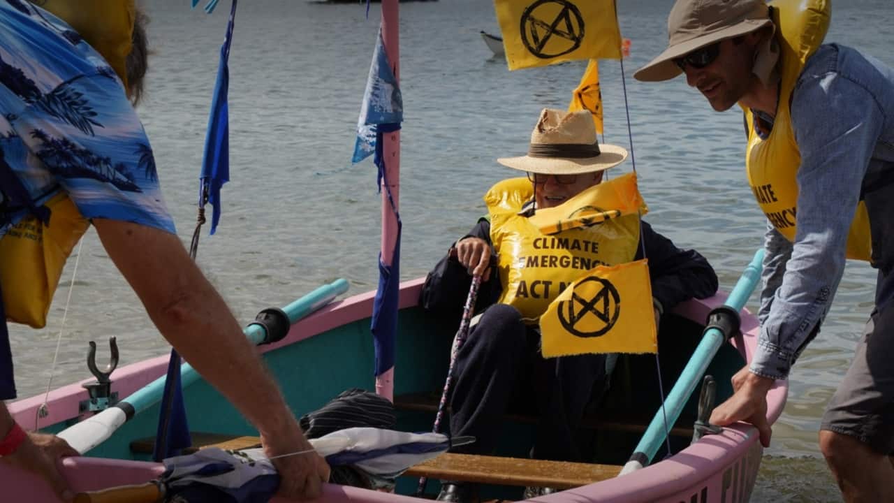 A man in a lifejacket in a pink boat
