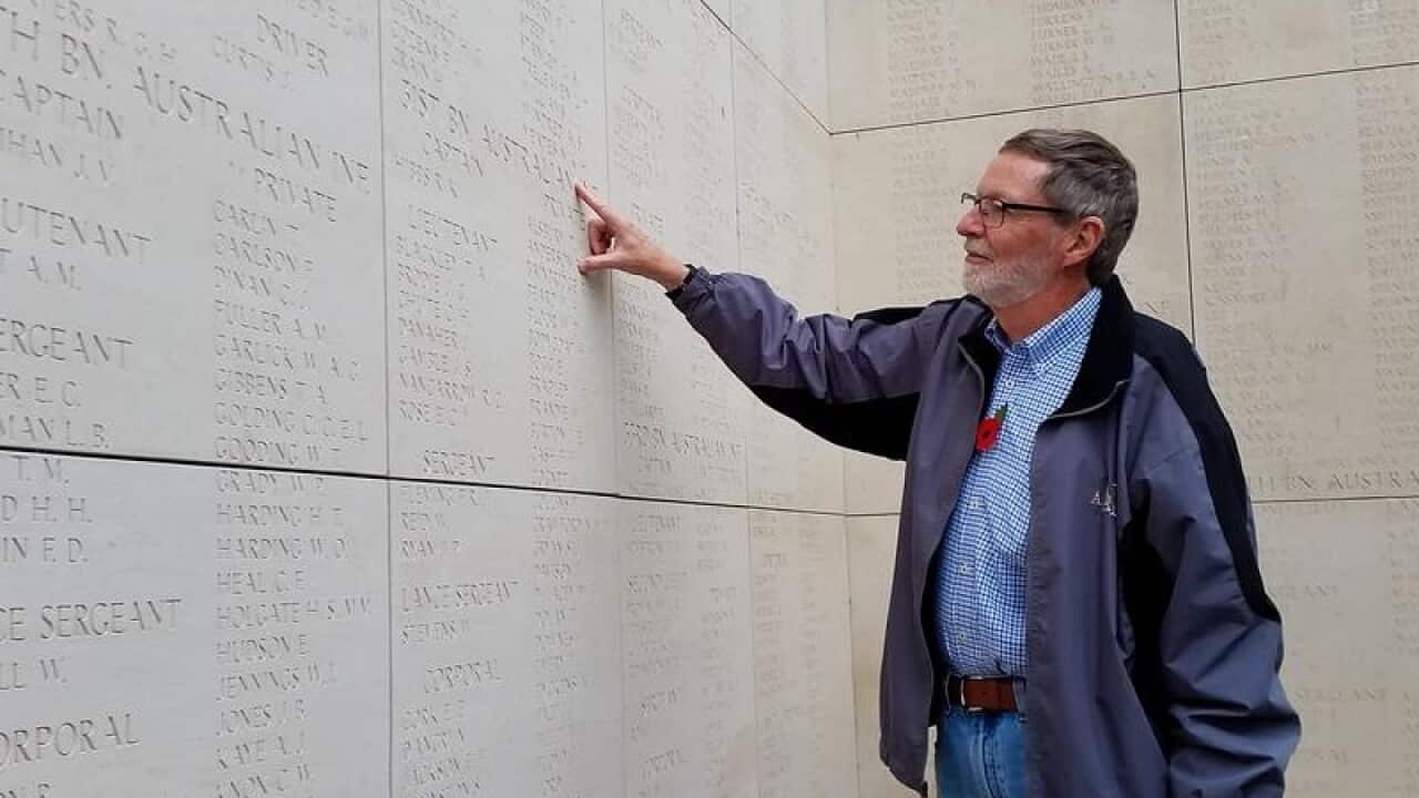 Australian Phil Clarke reads the names on a War memorial.