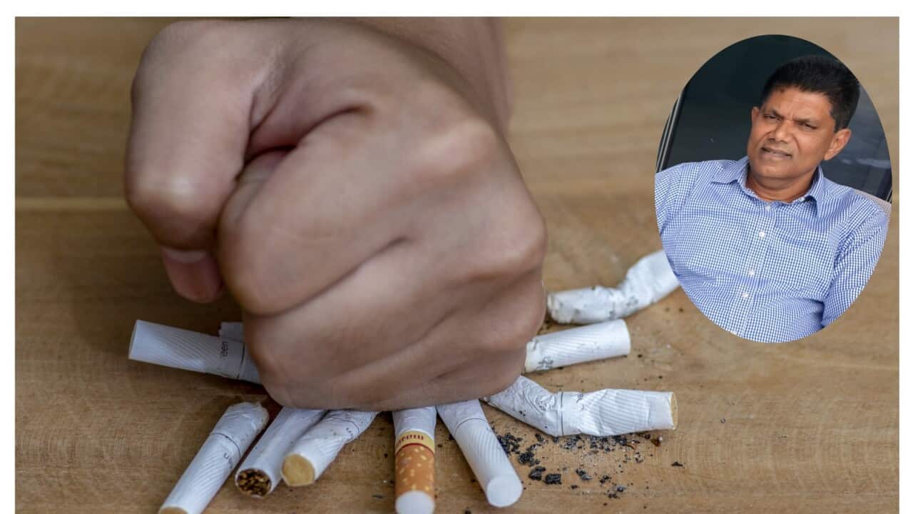 Male hand destroying cigarettes - stop smoking concept