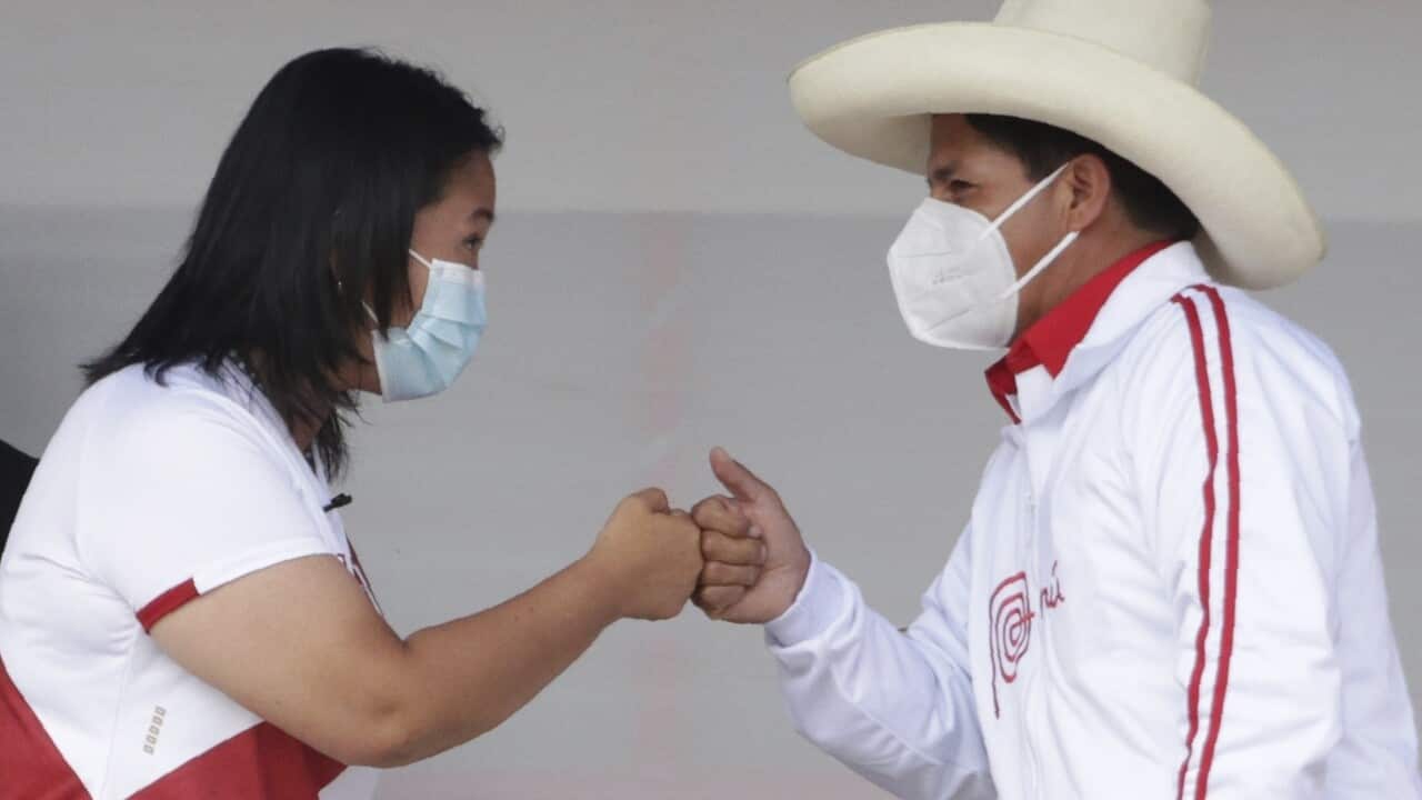 In this 1 May, 2021 file photo, presidential candidates Keiko Fujimori and Pedro Castillo fist bump at the end of a presidential debate.