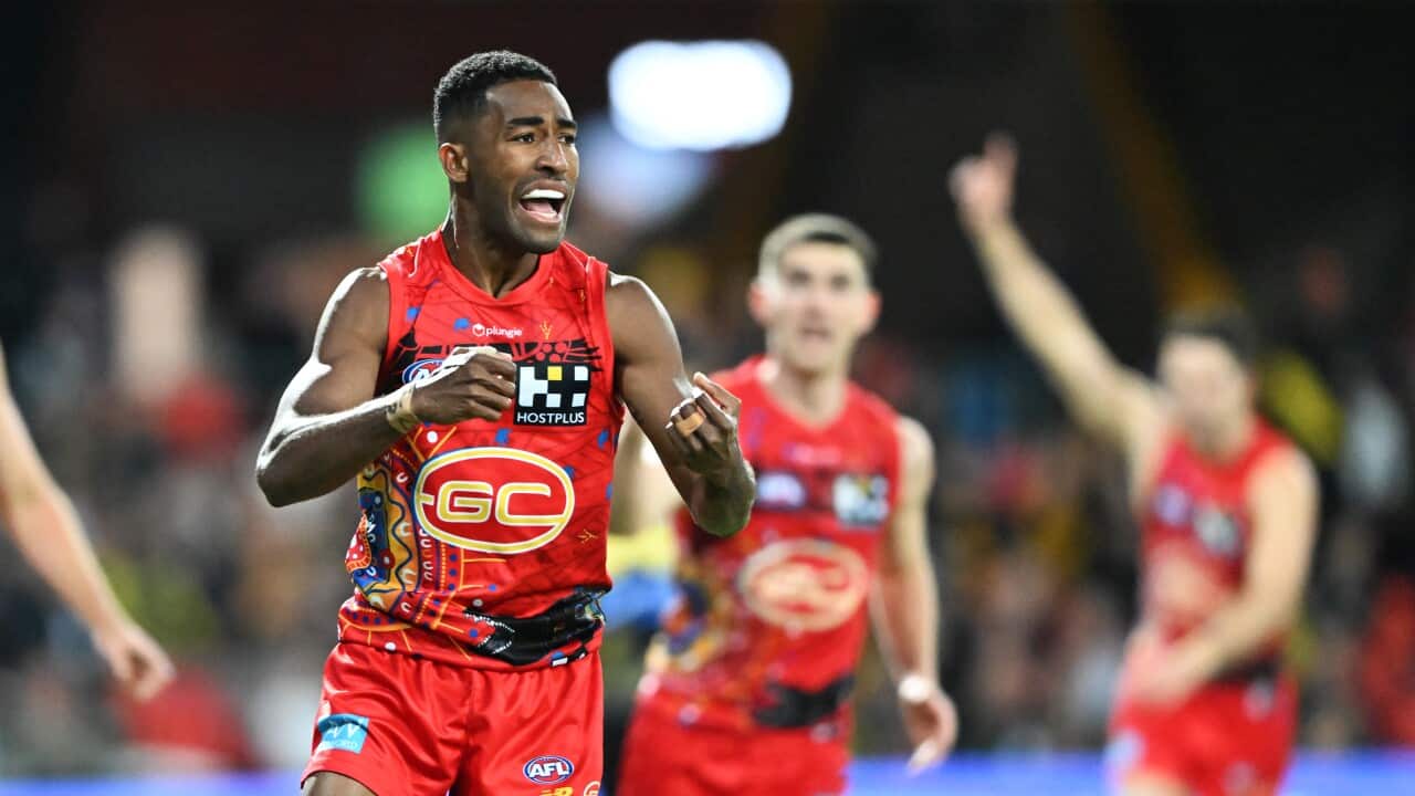 AFL player in red jersey.