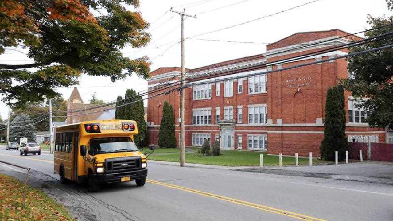 A school bus passes the Word of Life church on Thursday, Oct. 15, 2015, in New Hartford, N.Y.
