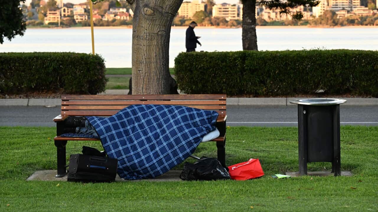 A homeless person is seen sleeping on a park bench in Pert.