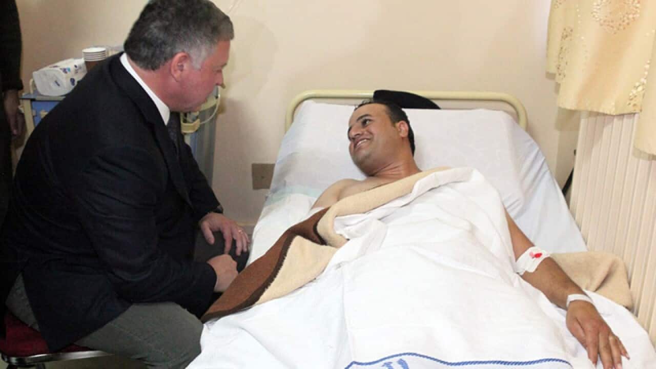 Jordan's King Abdullah II visits an injured victim