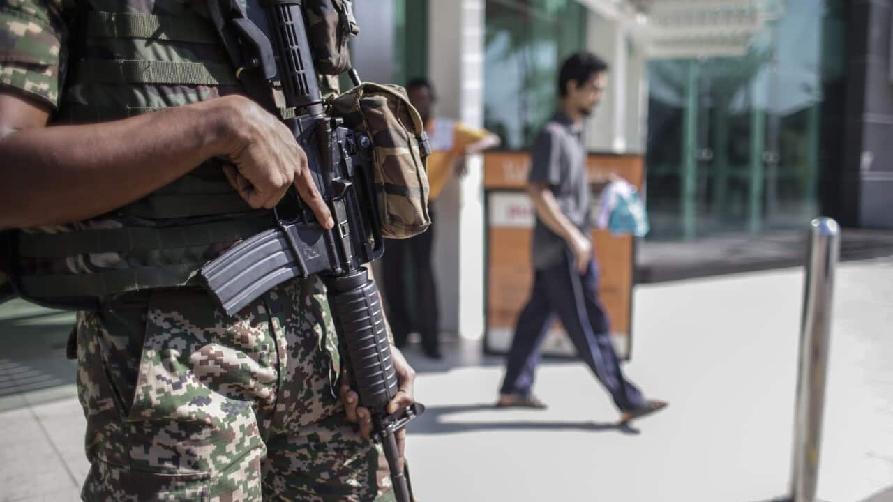 A Malaysian Armed Forces member secure the area outside a shopping mall in Kuala Lumpur, Malaysia