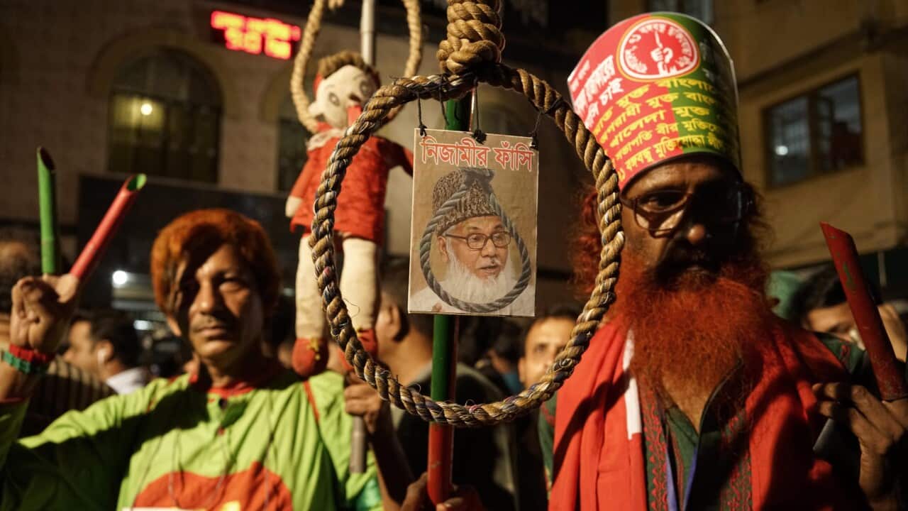 Members of Ganajagoron Mancha hold a photo of the convicted Jamaat e Islam leader Motiur Rahman Nizami