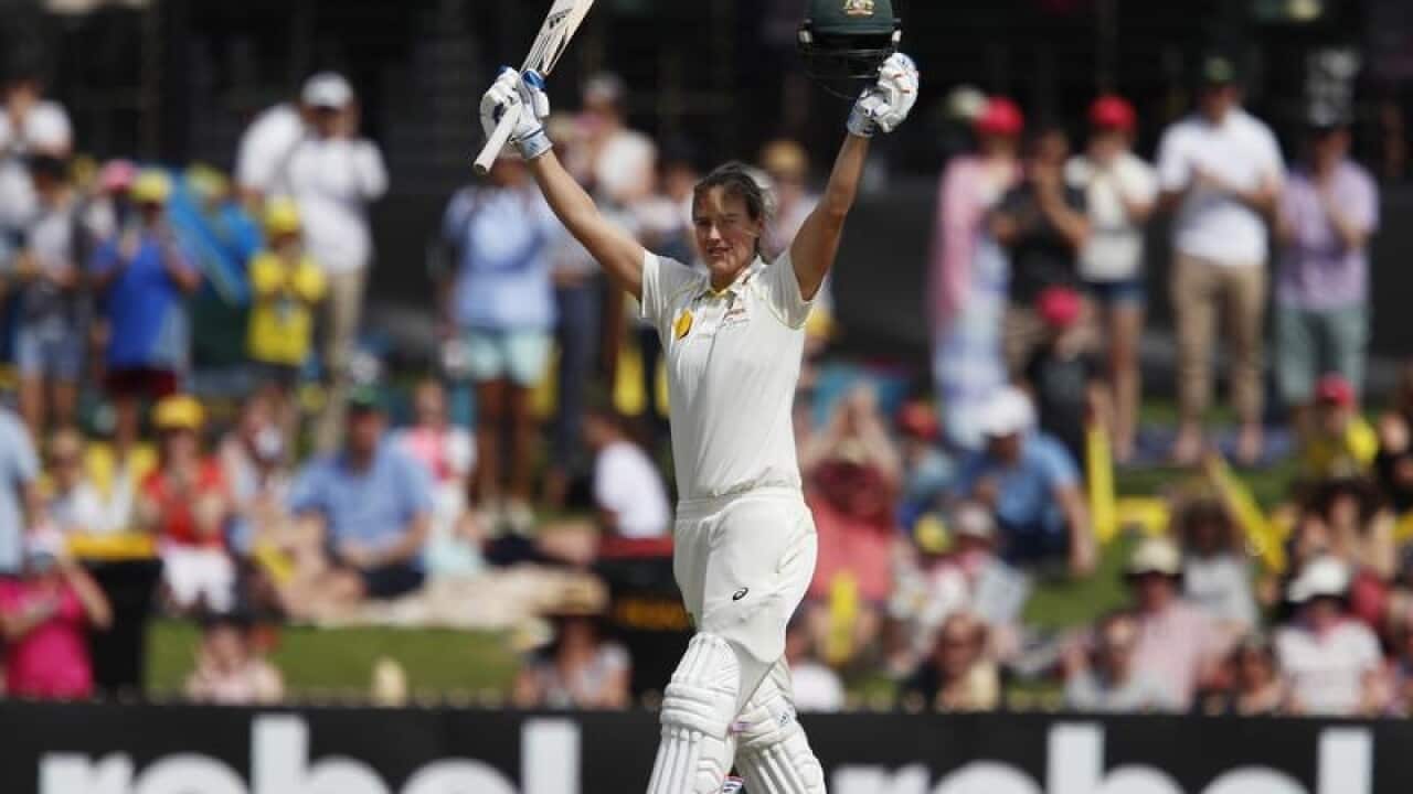Australia's Ellyse Perry gestures to the crowd after scoring a century