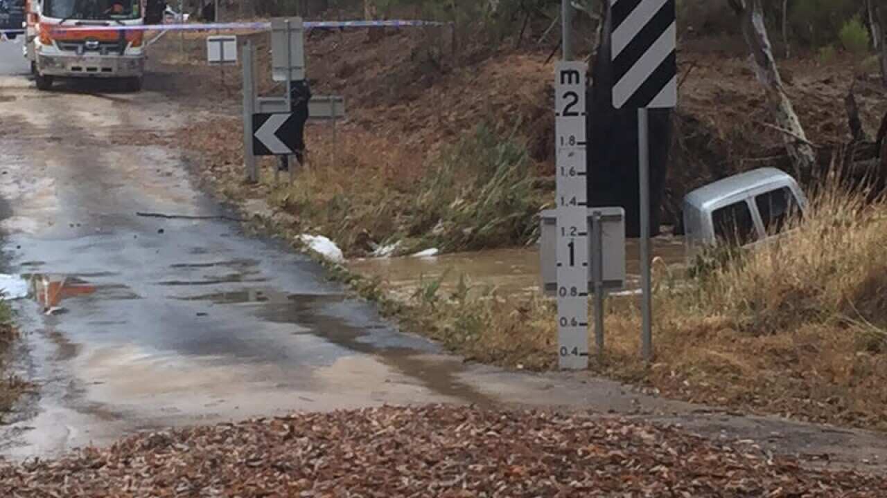 Supplied image of a car submerged in floodwaters in the central Victorian town of Seymour. A man was found dead after his car was found submerged. (AAP Image/Victoria Police)
