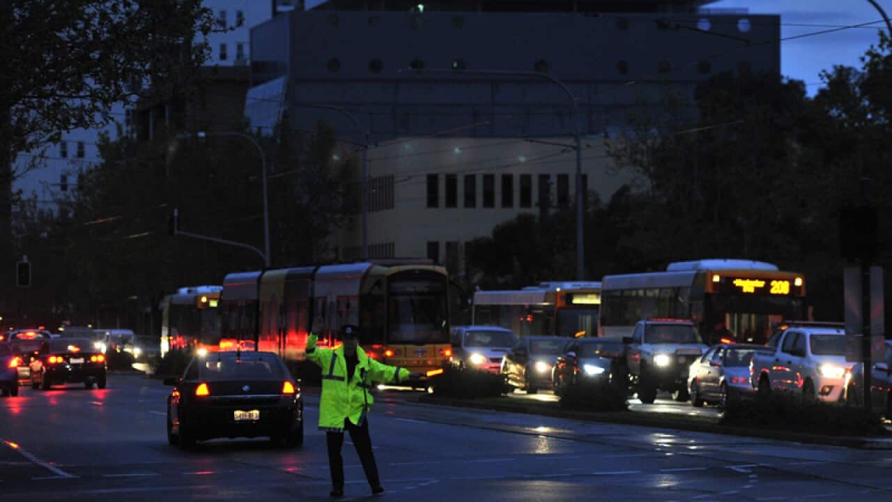 Police direct traffic after a blackout following storms in Adelaide