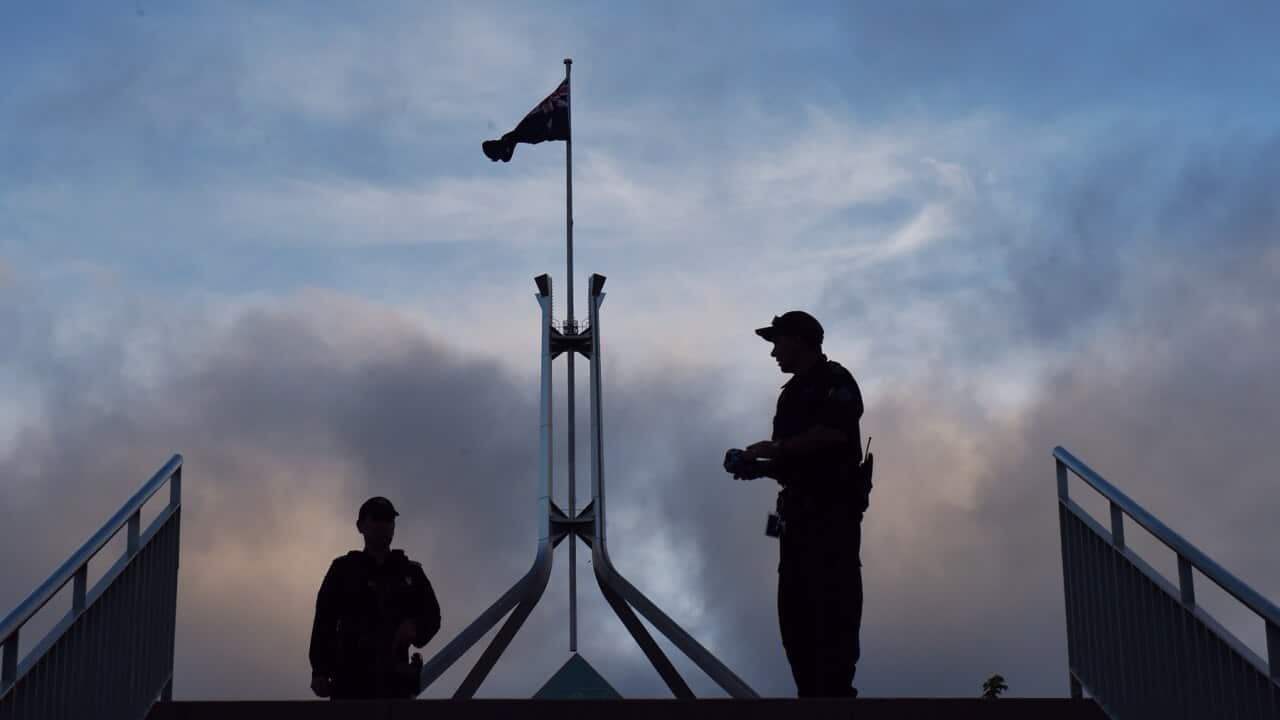 Armed Australian Federal Police officers are seen after new security directives are instigated at Parliament House in Canberra, Monday, Feb. 23, 2015. (AAP Image/Mick Tsikas) NO ARCHIVING
