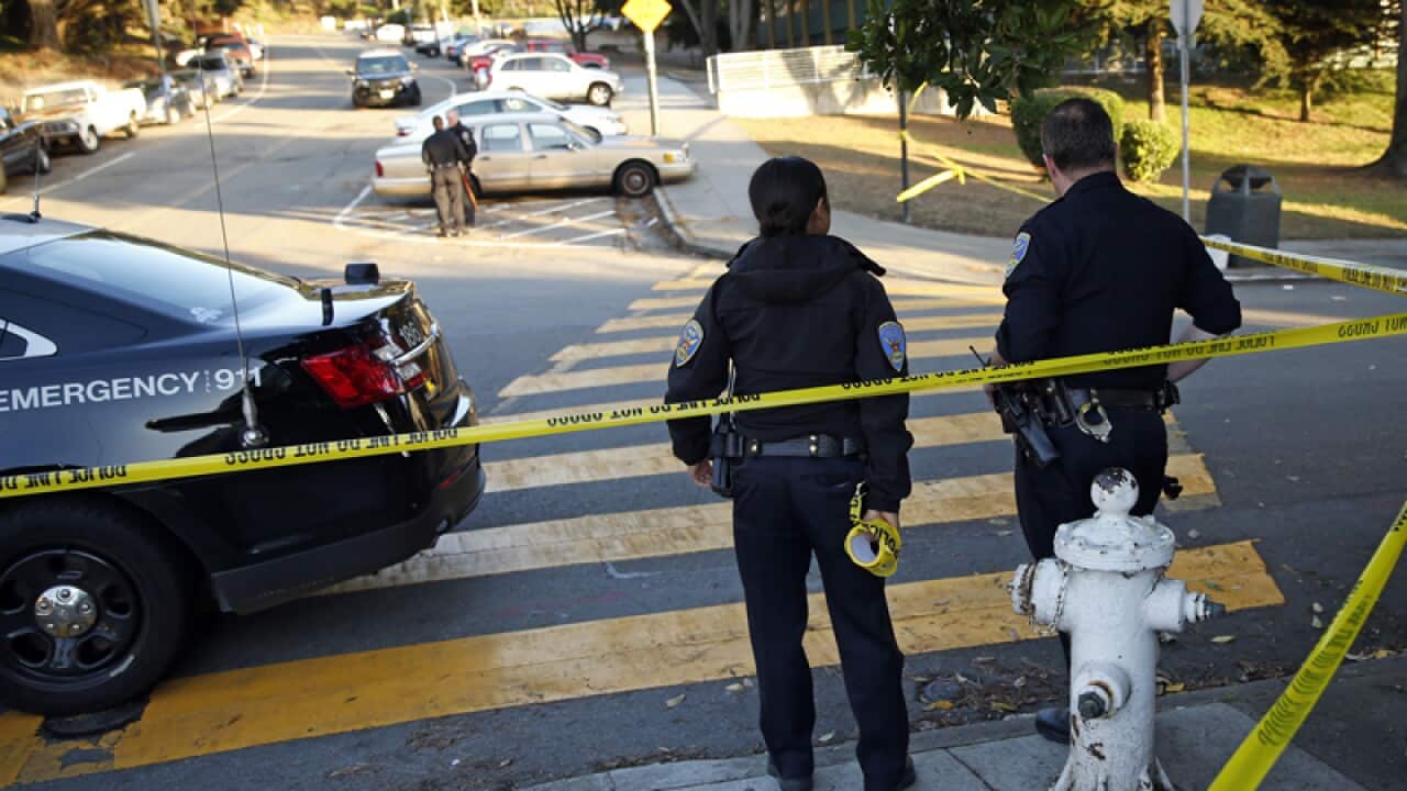 San Francisco Police stand at the site of a shooting