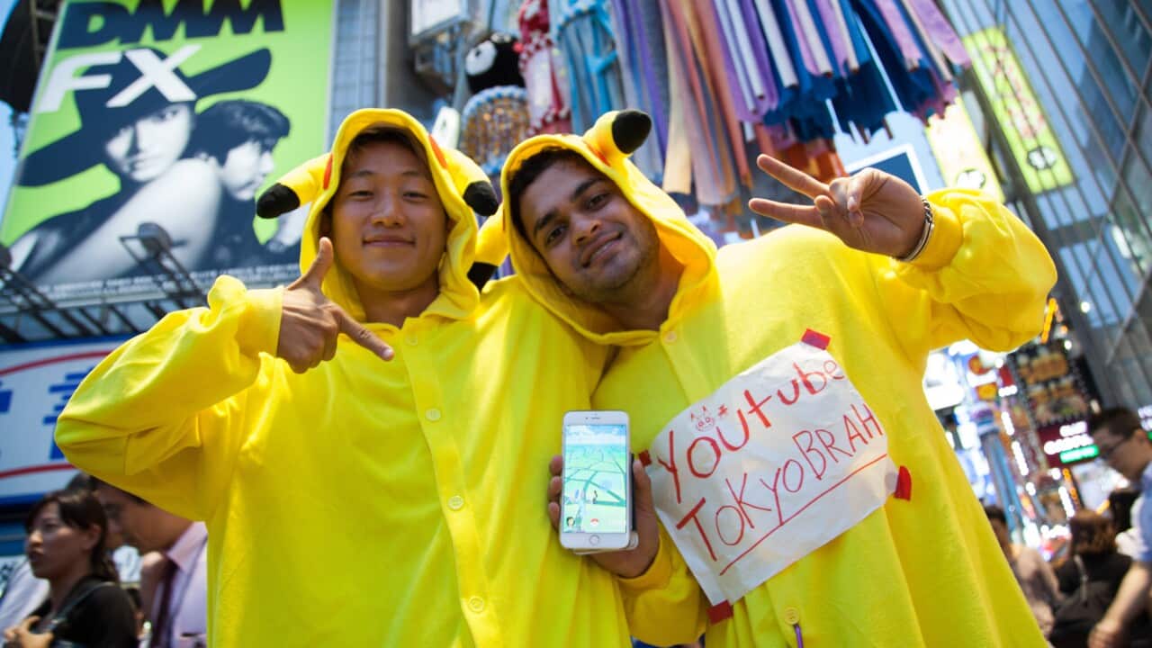 Fans try out Pokemon Go in Tokyo's Shibuya district on July 22, 2016, Tokyo, Japan