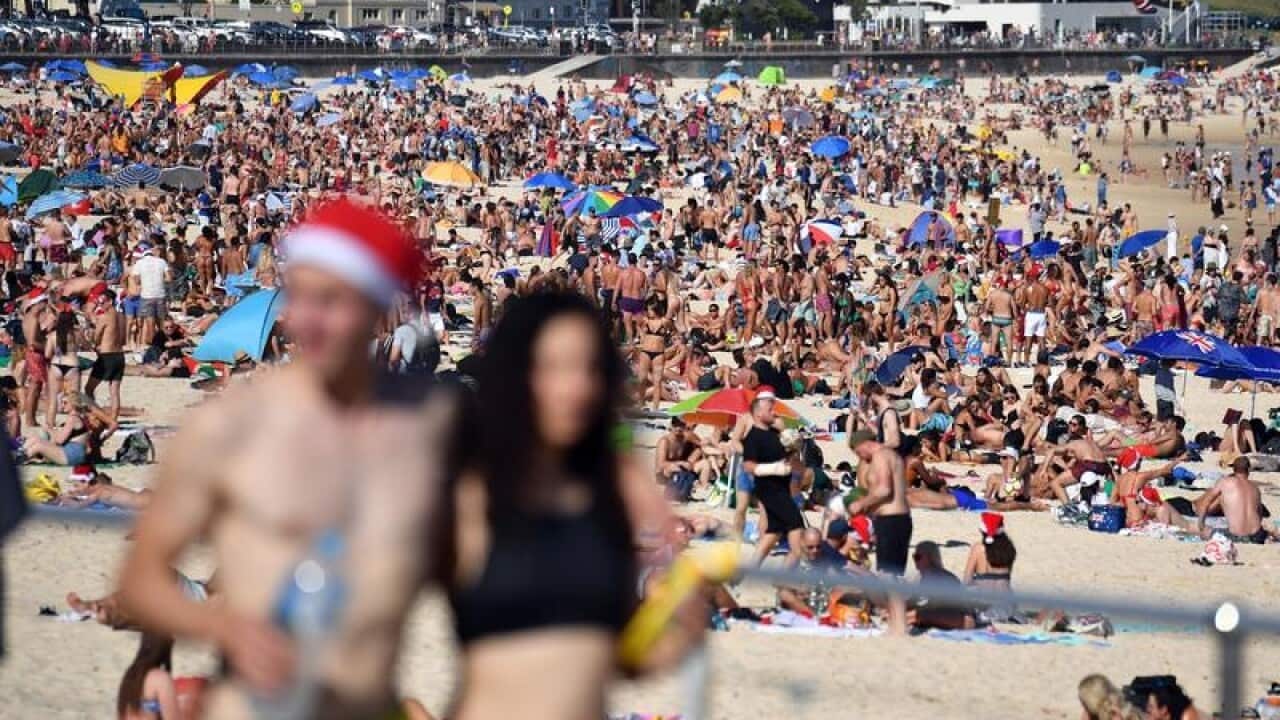 Beachgoers celebrate Christmas at Bondi Beach in Sydney