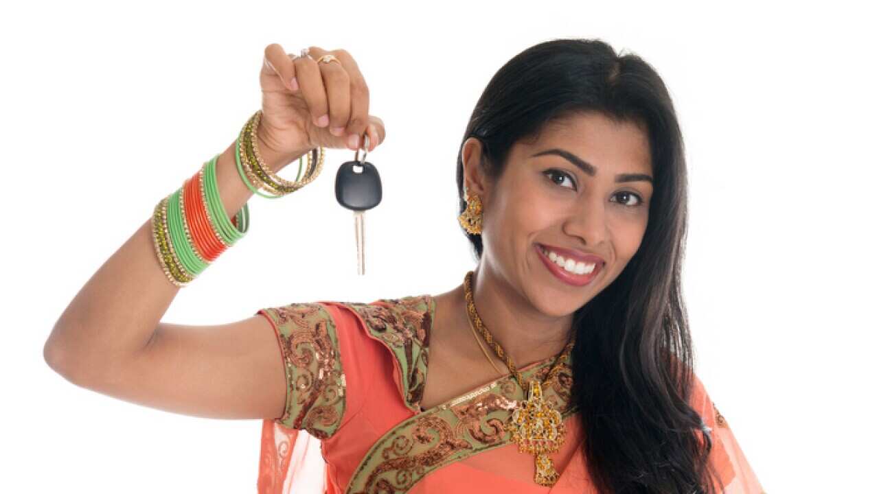 Indian woman holding car key