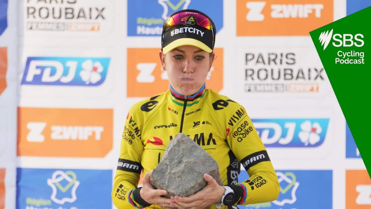 Pauline Ferrand Prevot, of France, lifts the cobblestone trophy after winning the Paris-Roubaix cycling race in Roubaix, France, Saturday, April 12, 2025. (AP Photo/Thibault Camus)