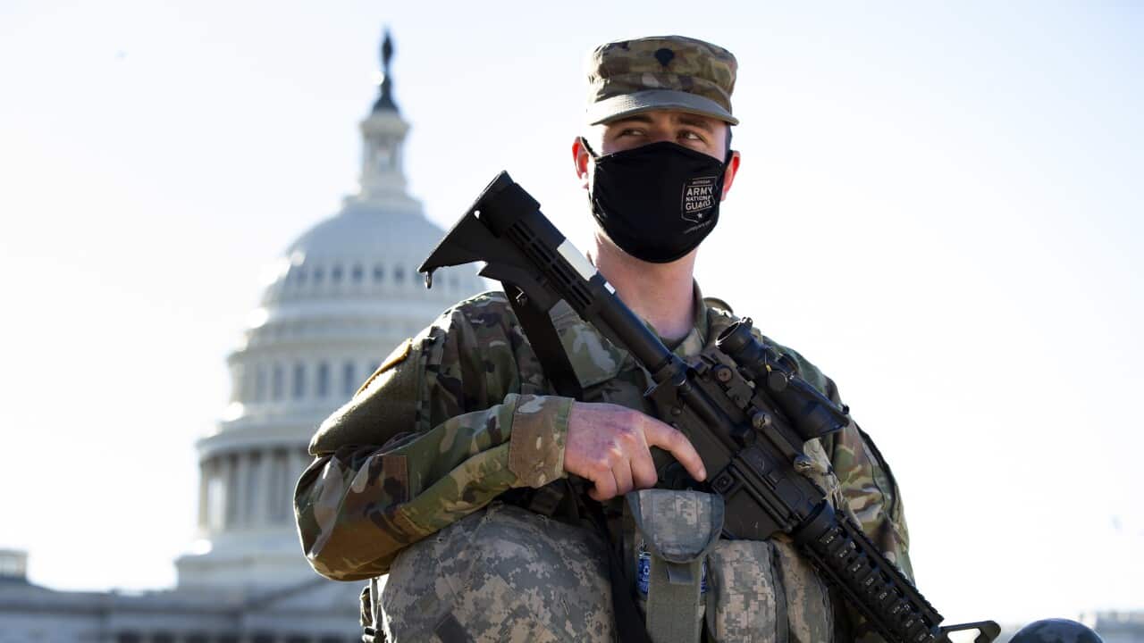 A member of the National Guard stands at the East Front of the US Capitol in Washington, DC, 3 March 2021.