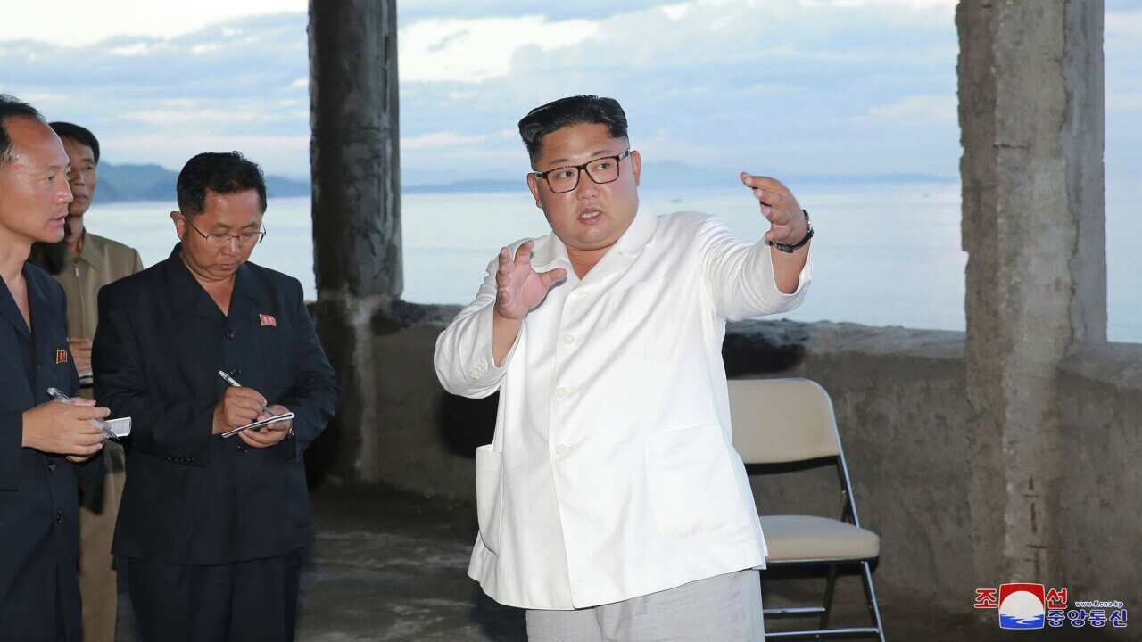 North Korean leader Kim Jong Un gestures during a visit to the construction site of a hotel in North Hamgyong Province, North Korea.